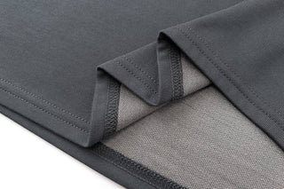 Folded black EMF apparel fabric with a textured surface, featuring reinforced edges, designed to shield against electromagnetic fields