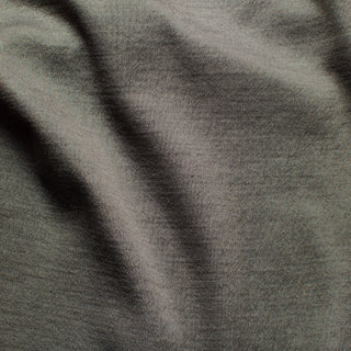 Close-up view of a textured dark fabric designed for an EMF - electromagnetic field apparel line, highlighting the intricate weave that contributes to its protective properties.